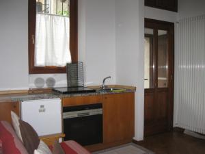 a kitchen with a sink and a stove top oven at La Casetta in Como