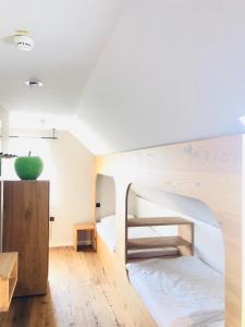 a room with a bunk bed with a green apple on it at Hotel Waldvogel in Leipheim