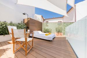 a balcony with a bed and a table and chairs at Fonda Llabres Boutique in Alcudia