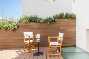 two chairs and a table on a patio at Fonda Llabres Boutique in Alcudia