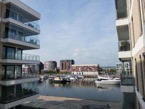 a group of boats in a river between two buildings at Heimathaven 2 in Bremerhaven