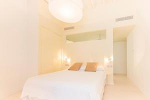 a bedroom with a white bed with two pillows on it at Fonda Llabres Boutique in Alcudia