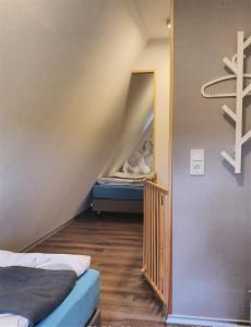 a room with a staircase with a bunk bed at Wanderhütte Zum Glückstal in Neuhaus am Rennweg
