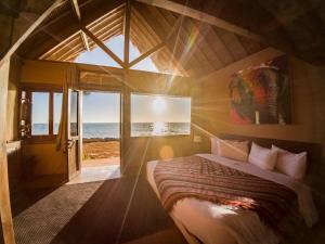a bedroom with a bed with a view of the ocean at Westpoint Dakhla in Dakhla