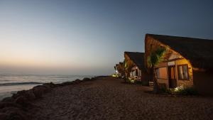 a row of houses on a beach next to the ocean at Westpoint Dakhla in Dakhla