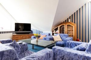 a living room with blue couches and a table at Humala Guest House in Tallinn