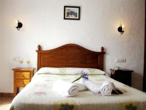 a bed that has a blanket on it at Hotel Oasis Atalaya in Conil de la Frontera