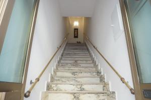 a staircase in a building with marble floors and white walls at AleAndre in Foggia