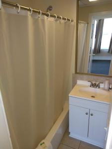 a bathroom with a sink and a mirror at Hotel Wayne in Honesdale