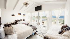 a bedroom with two beds and a view of the ocean at PK25 Dakhla in Dakhla