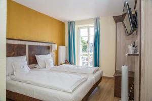 En eller flere senger på et rom på Hotel & Gästehaus Seehof