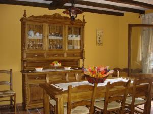 a dining room with a table and a wooden hutch at CASA RURAL CASA CANDI in El Arenal +23 photos