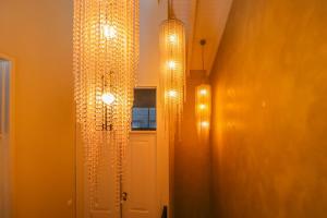 a room with two chandeliers hanging from the ceiling at Villa Zawaia B&B in Lagos
