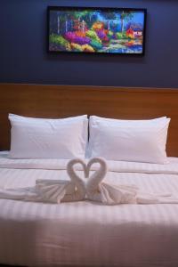a couple of heart shaped towels on a bed at S.S.Hotel Nangrong in Nang Rong
