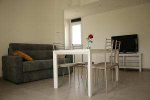a living room with a table and a couch at casa in campagna alle porte di Rimini 3min fiera 3 min mare in Rimini