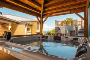 a hot tub on the patio of a house at T3 - 100m2 - Résidence Georgette in Terre Sainte