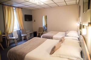 a hotel room with two beds and a desk at Logis Hôtel Restaurant Azalées in Tournon-sur-Rhône