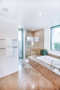 a large bathroom with a tub and a shower at Contemporary Dreams in Palm Springs