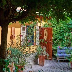 a garden with a wooden door and a bench at Biggi‘s Garten-Finca in Flonheim +3 photos