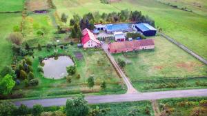 an aerial view of a house with a large yard at Agroturystyka nad stawem Mazuchówka in Wydminy +16 photos