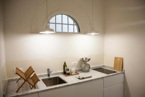 a kitchen with a sink and a window at Pietrapiana Boutique Apartments in Florence