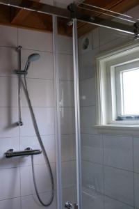 a shower in a bathroom with a glass door at Mini appartement De Fabriek in Nijmegen
