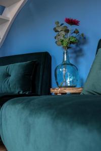 a vase with a flower in it sitting on a table at Mini appartement De Fabriek in Nijmegen