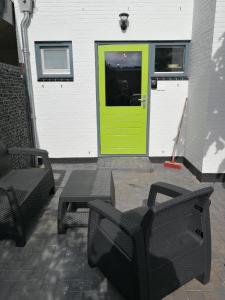 a room with a door open and a chair in front of it at JaBaKi Green Studio in Hoofddorp