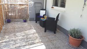 a patio with two chairs and a table at Apartmani Kulin 2 in Kaštela