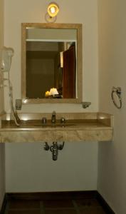 a bathroom with a sink and a mirror at Montecassino in Capilla del Monte