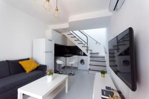 a living room with a blue couch and a white table at bungalow with terrace near the beach in San Bartolomé de Tirajana