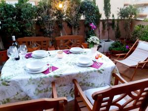una mesa con platos y servilletas en el patio en Terraza y Playa Costa Tropical en Torrenueva