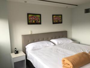 Postel nebo postele na pokoji v ubytování Hotel Garden City Boutique