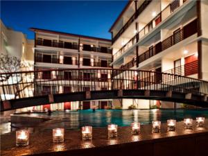 a group of glasses sitting on a table in front of a building at Sun Island Hotel & Spa Kuta in Kuta