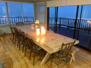 una mesa de madera con velas y sillas en el balcón en Seaview Beach House - 7 on Lynx, Great Brak River, en Groot Brak Rivier 17 fotos más