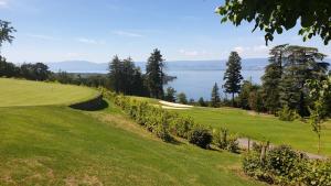 a golf course with a view of the ocean at Maison La Rive in Publier