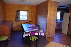 a kitchen with a table and chairs in a room at Au Beolin in Houffalize