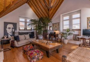 a living room with a couch and a table at Restored Winery On The Atlantic 3bedroom house in Sintra