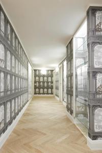 an empty hallway with a wall of books at Casa Vittoria Napoli - Santa Lucia in Naples