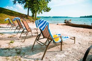 a row of lawn chairs sitting on a beach at Long Cove Resort and Marina in Charlotte