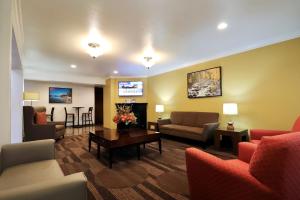a living room with couches chairs and a table at Best Western Chieftain Inn in Wenatchee