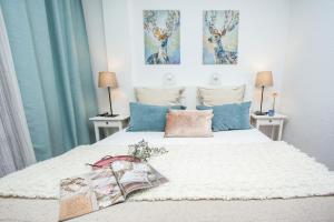 a bedroom with a large white bed with two lamps at Spectacular Ocean Apartment with AirCon in Golden Mile of Las Americas in Arona
