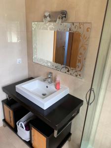 a bathroom with a sink and a mirror at The Right Place to Relax in Santo António +30 photos