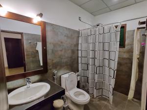 a bathroom with a sink and a toilet and a shower at Sigiri Shen Residence in Sigiriya