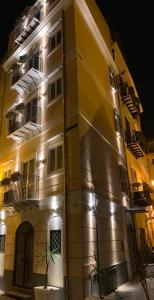 a yellow building with lights on it at night at Dietro la Cattedrale in Palermo