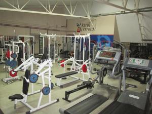 a gym with several tread machines and weights at Errota Ostatua in Durango