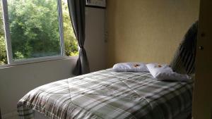 En eller flere senge i et værelse på Apartamento Bay Conceicao