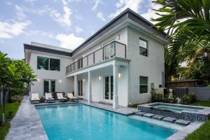 a house with a swimming pool in front of a house at CASA HERMÈS Wilton Manor - Gay Guesthouse in Fort Lauderdale