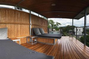 a large wooden deck with a bed on a boat at Horizon Lodge Potrero in Potrero