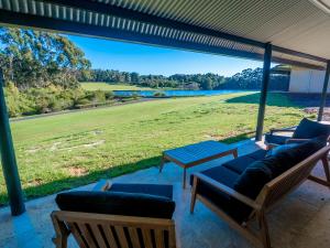 a patio with couches and a view of a field at Tanah Marah in Margaret River Town
